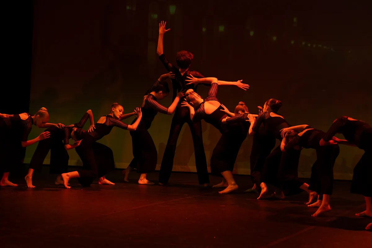 Contemporary dancers creating an artistic group shape on stage with JL Dance Academy in Ripley