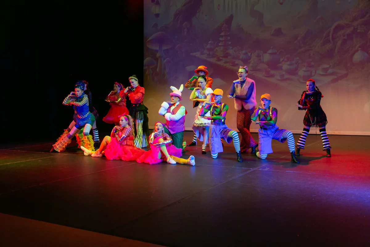 Musical Theatre students posing together on stage with JL Dance Academy in Ripley