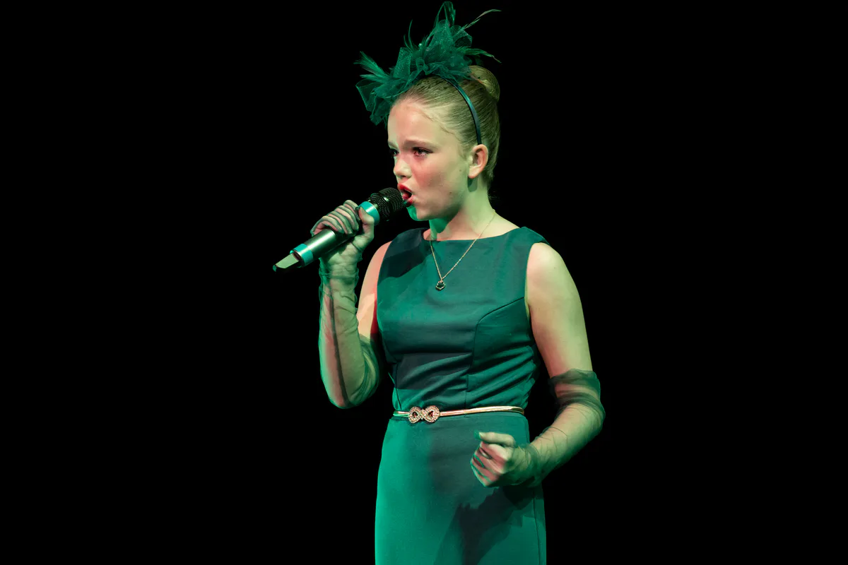 Vocal student singing a solo into a microphone with JL Dance Academy in Ripley