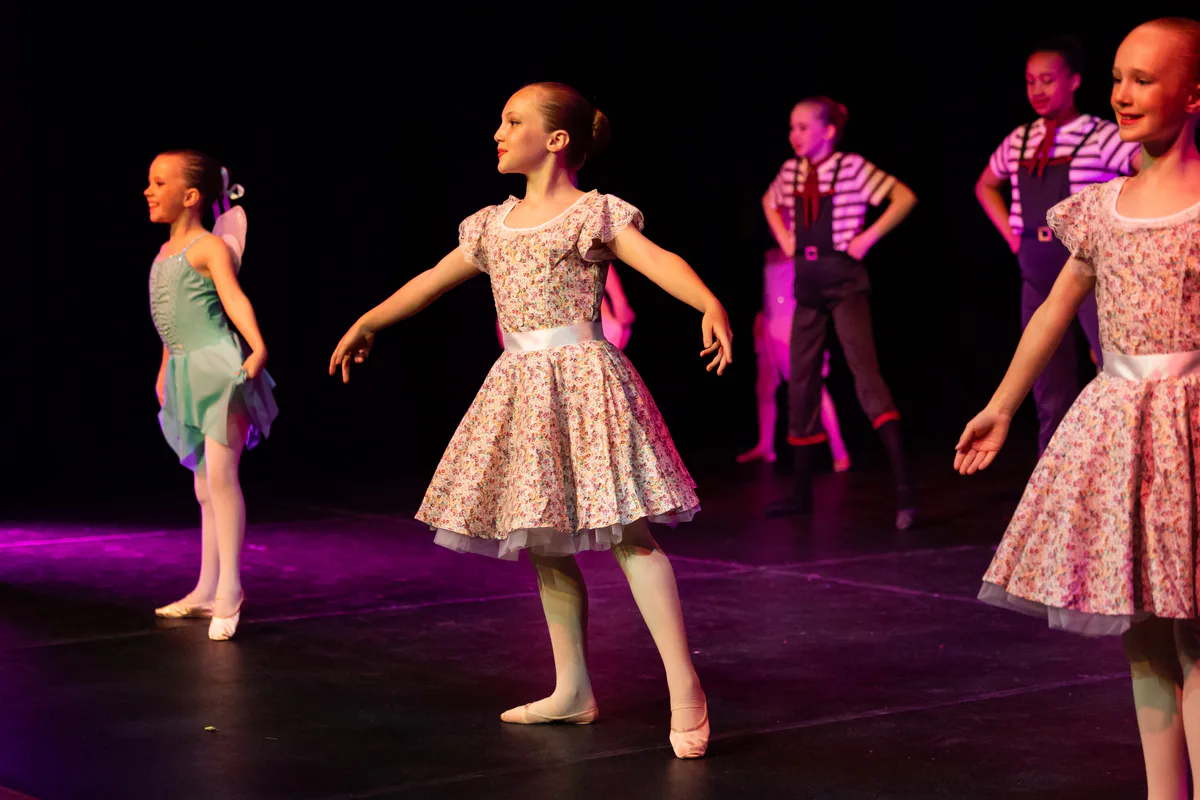 Young ballet dancer holding a poised classical position on stage with JL Dance Academy in Ripley
